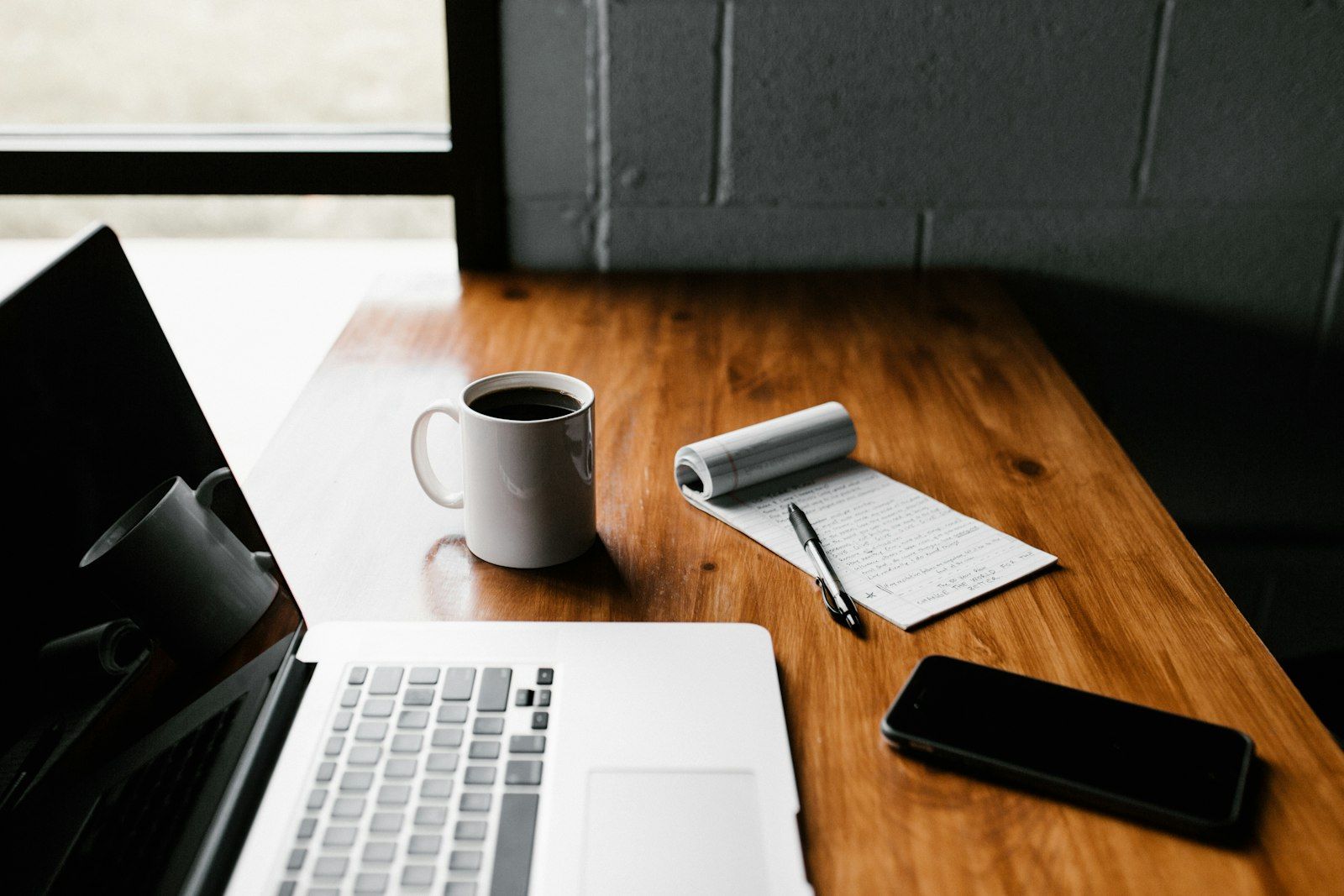 A calm desk with a laptop and coffee